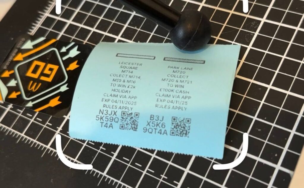 Digital QR code monopoly pieces printed on a cheap receipt printer in low quality being scanned by the iOS scanner app.