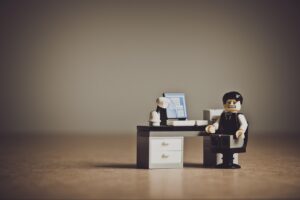 Despaired LEGO businessman sitting at a desk